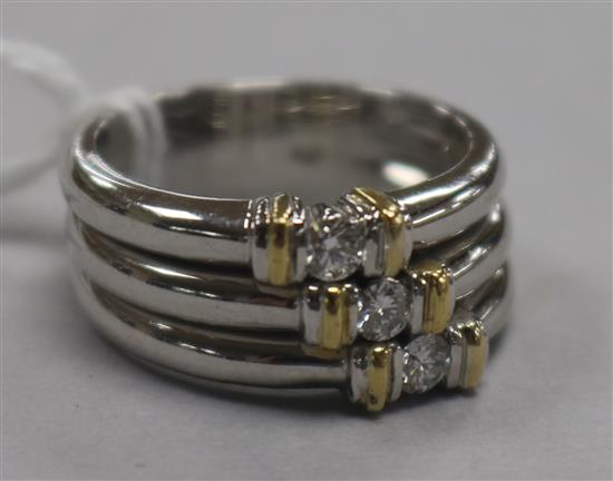 A modern 18ct white gold and diamond triple band ring, size O.
